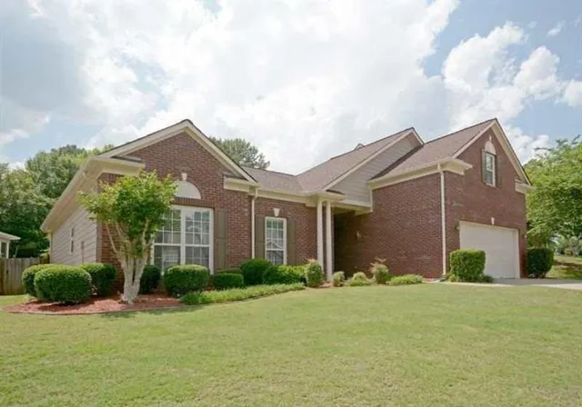 a front view of house with yard and green space