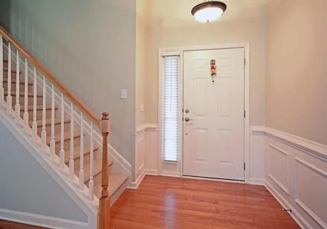 a view of an entryway with wooden floor