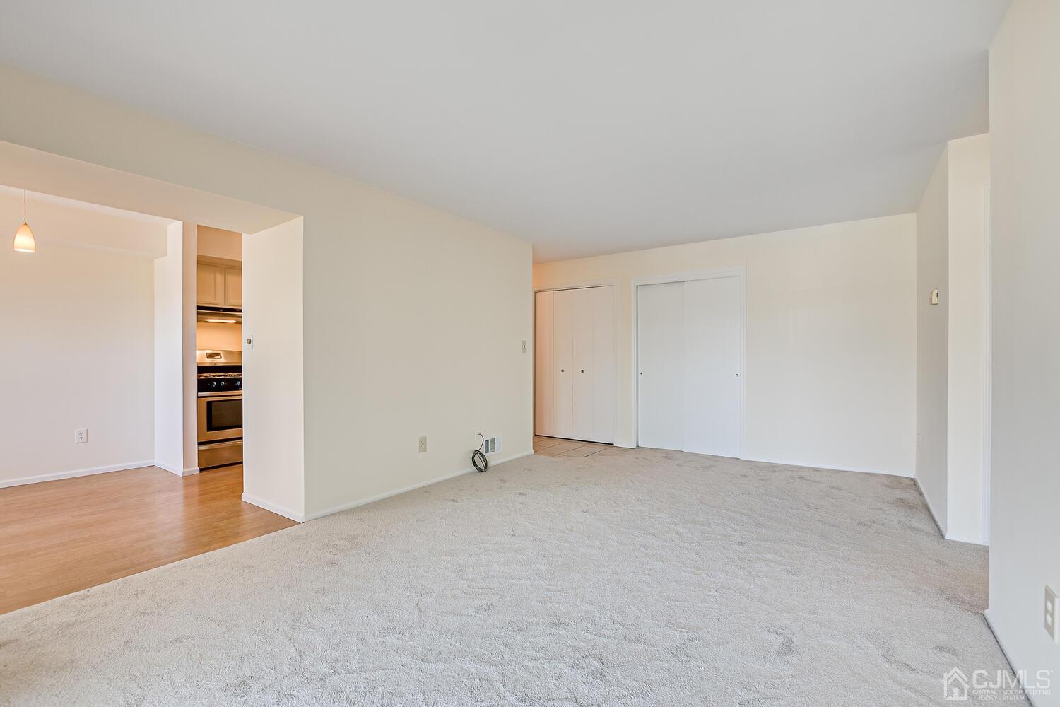 116 Keystone Court, Unit 1162 Woodbridge, NJ 07095 - Photo 14 of 28 an empty room with wooden floor and closet