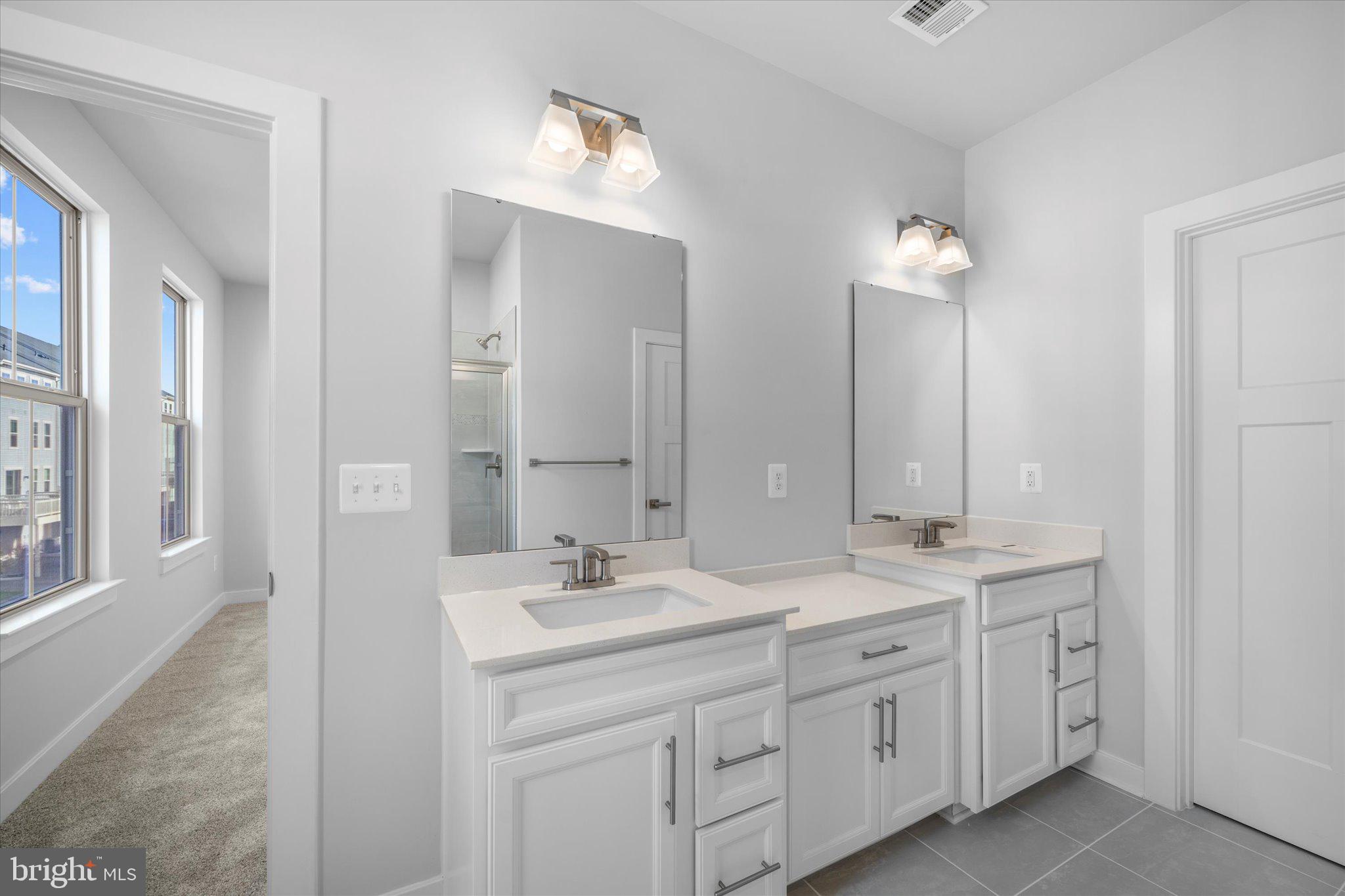 42530 Invergordon Terrace Sterling, VA 20166 - Photo 18 of 39 a bathroom with double sink and a mirror