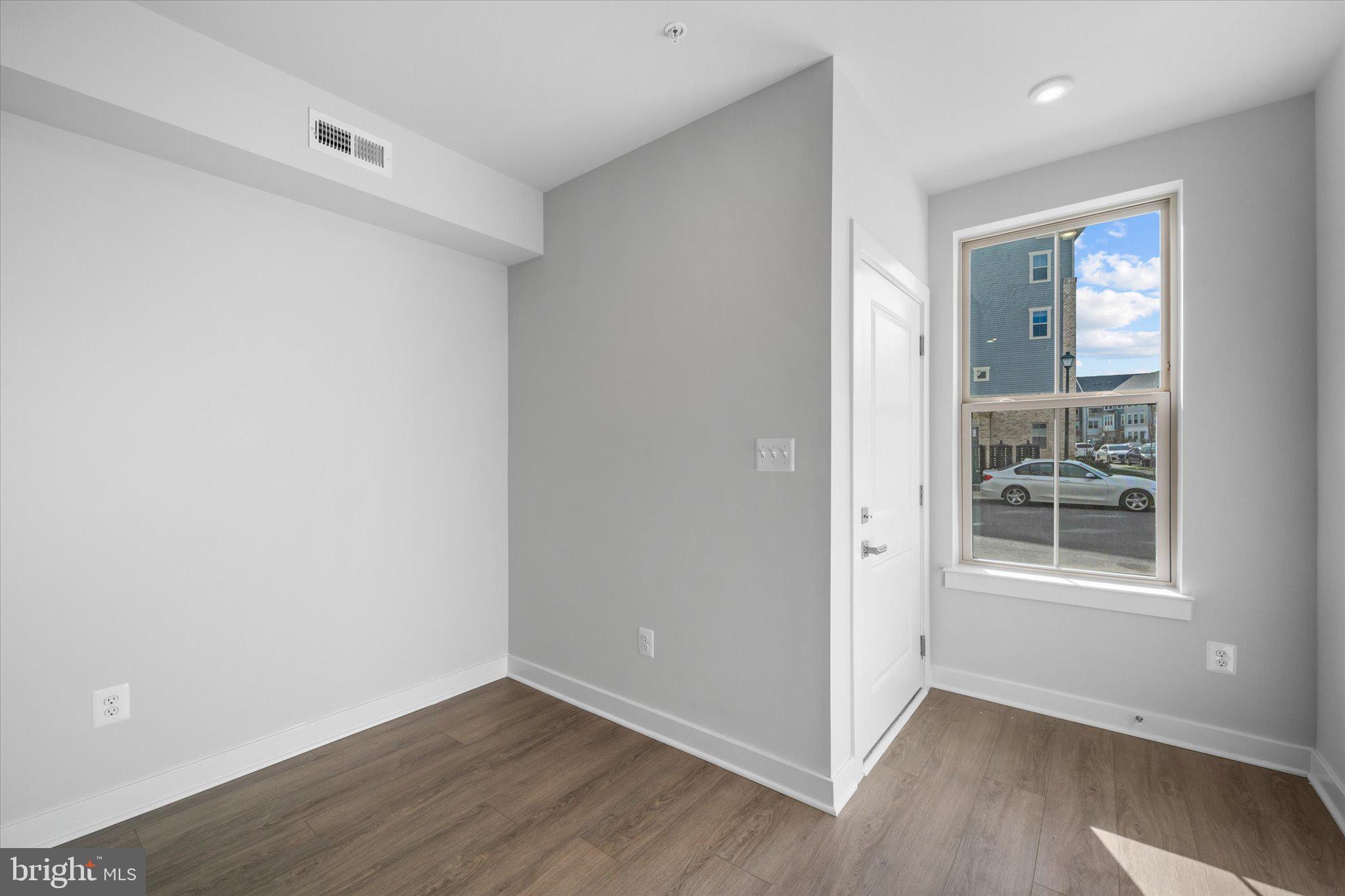 42530 Invergordon Terrace Sterling, VA 20166 - Photo 20 of 39 an empty room with wooden floor and windows