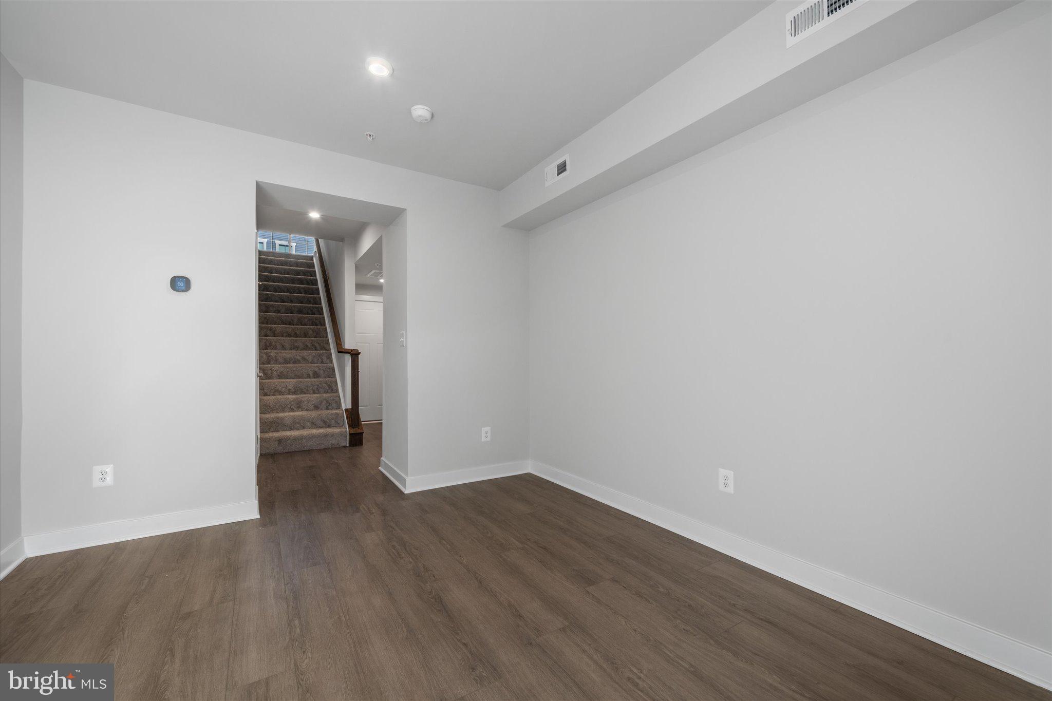 42530 Invergordon Terrace Sterling, VA 20166 - Photo 22 of 39 a view of an empty room with wooden floor and closet