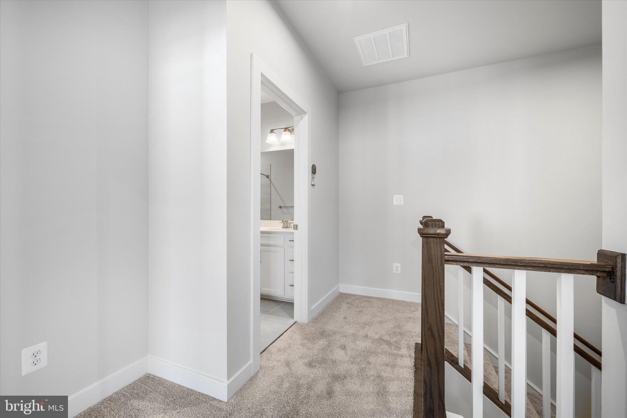 42530 Invergordon Terrace Sterling, VA 20166 - Photo 25 of 39 a view of a hallway with a white walls and wooden floor