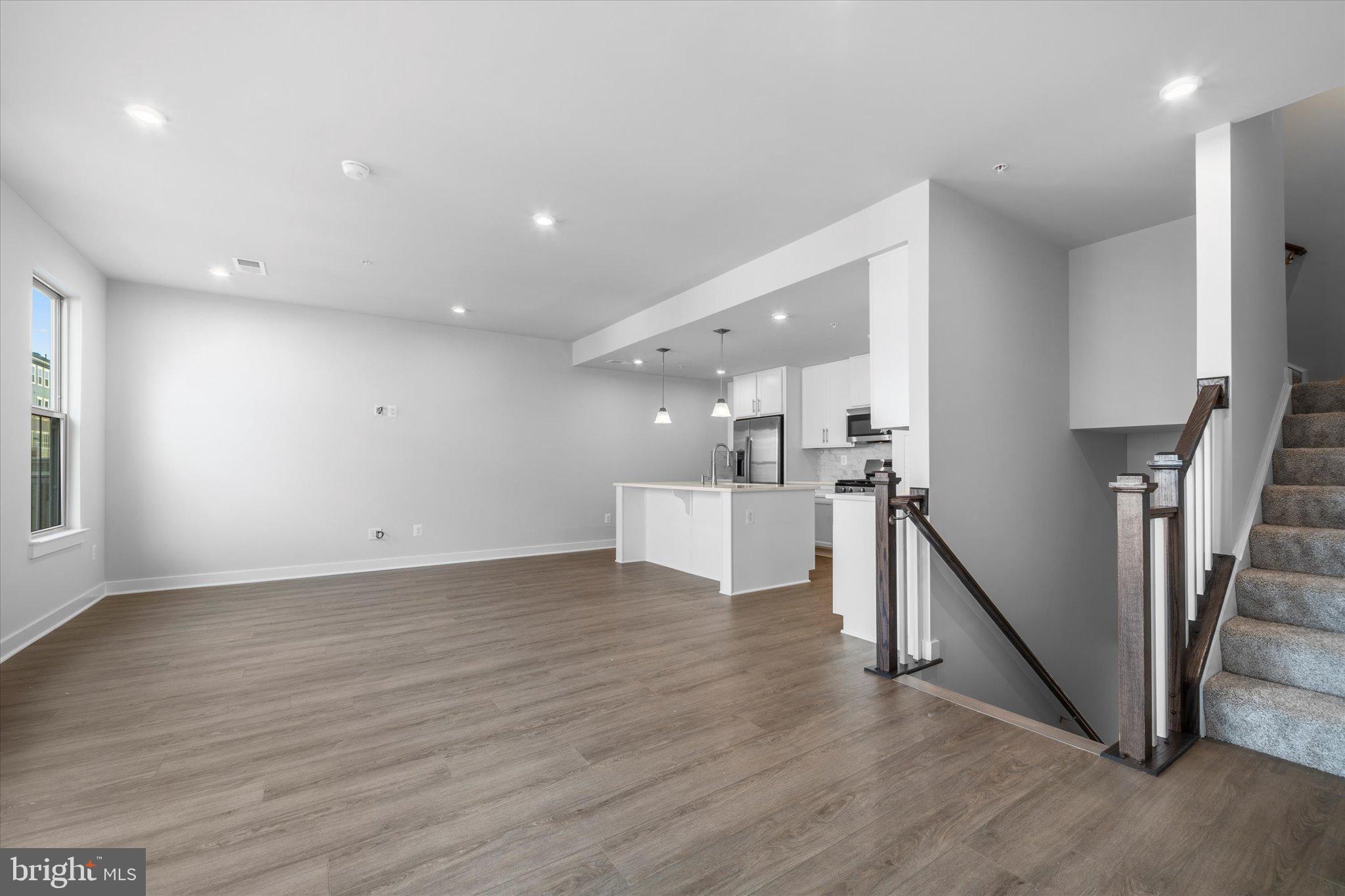 42530 Invergordon Terrace Sterling, VA 20166 - Photo 5 of 39 a view of a kitchen with wooden floor and stairs