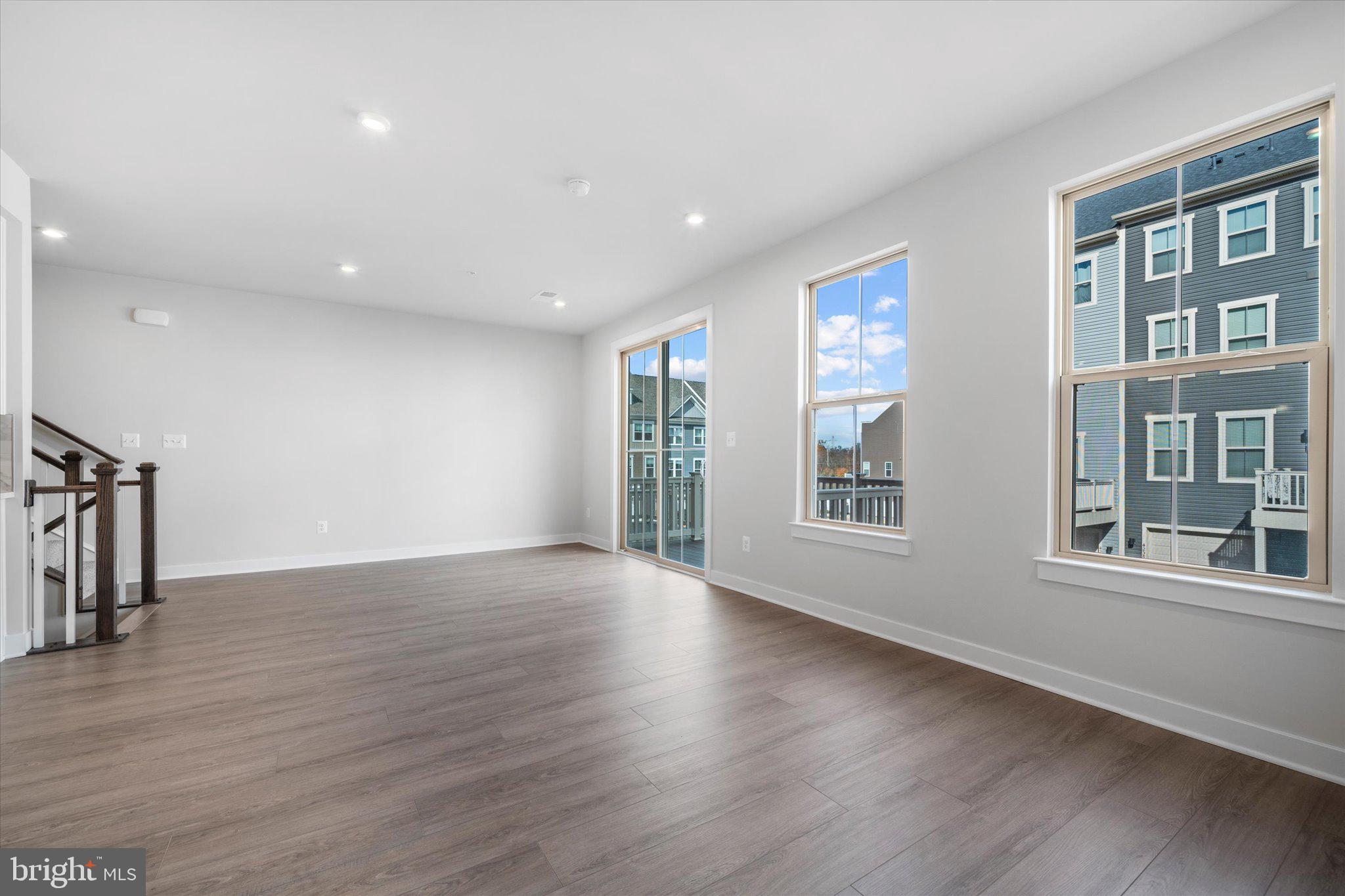 42530 Invergordon Terrace Sterling, VA 20166 - Photo 6 of 39 a view of an empty room with wooden floor and a window