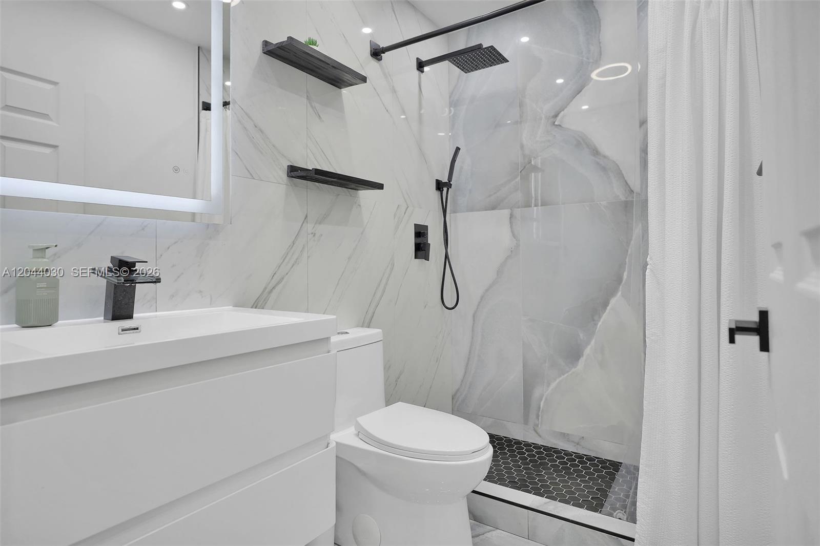 12551 Southwest 223rd Street Miami, FL 33170 - Photo 11 of 35 a bathroom with a sink a toilet and shower