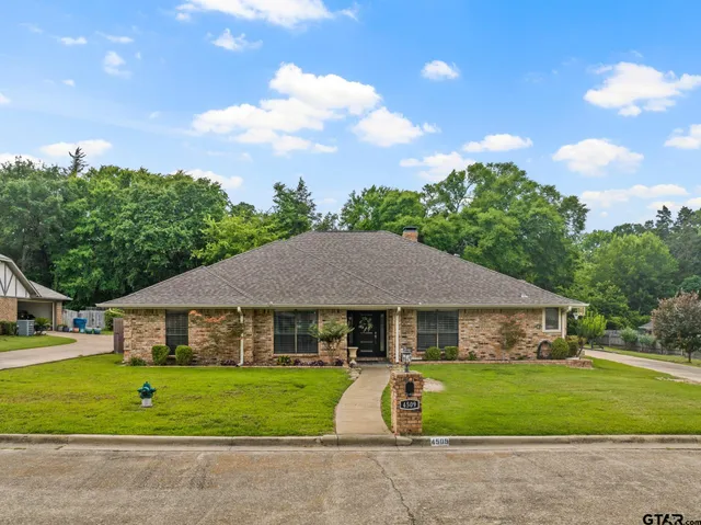 a aerial view of a house next to a yard