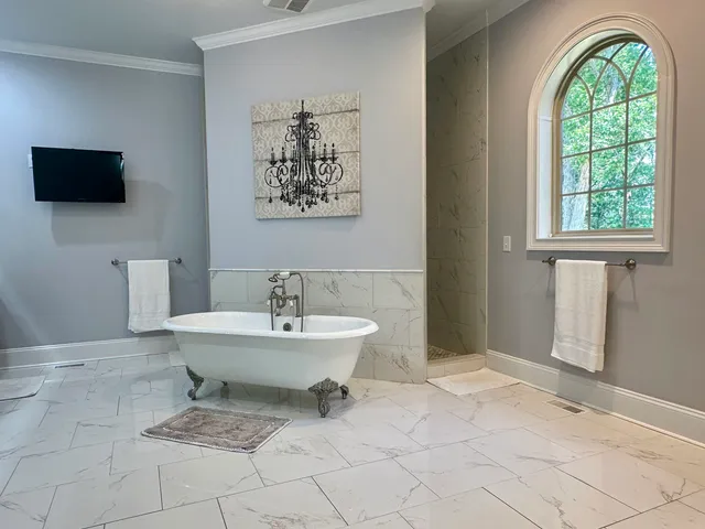 a living room with furniture flat screen tv and wooden floor