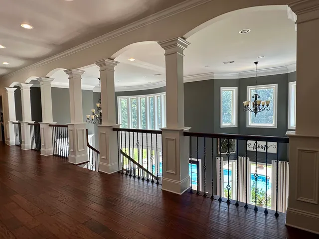 a bathroom with a double vanity sink a large mirror and a bathtub