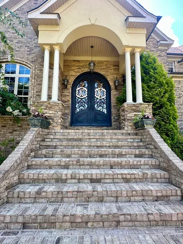 a front view of a house with a garden