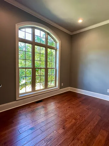 a view of a dining room with a table and chairs