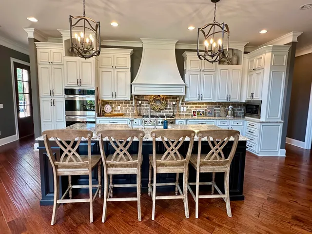 a view of a dining room with furniture wooden floor and chandelier