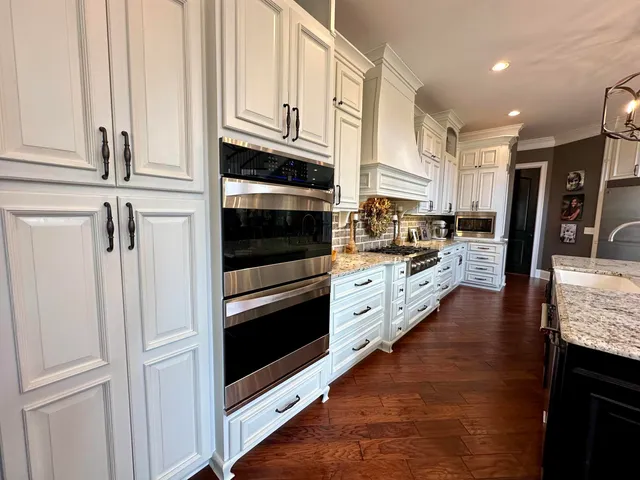 a kitchen with stainless steel appliances a stove microwave and cabinets