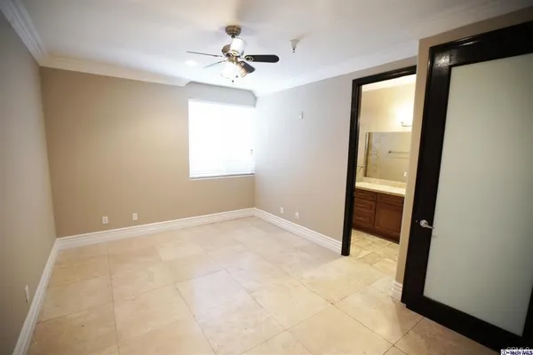 an empty room with windows and closet