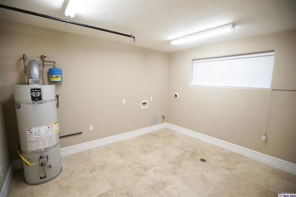 a view of a room with wooden floor and white walls