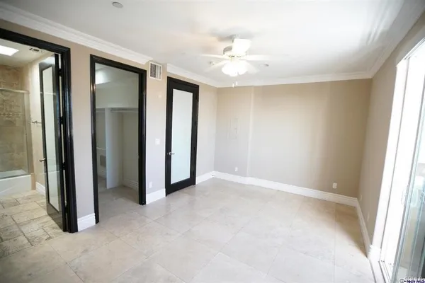 an empty room with windows and closet