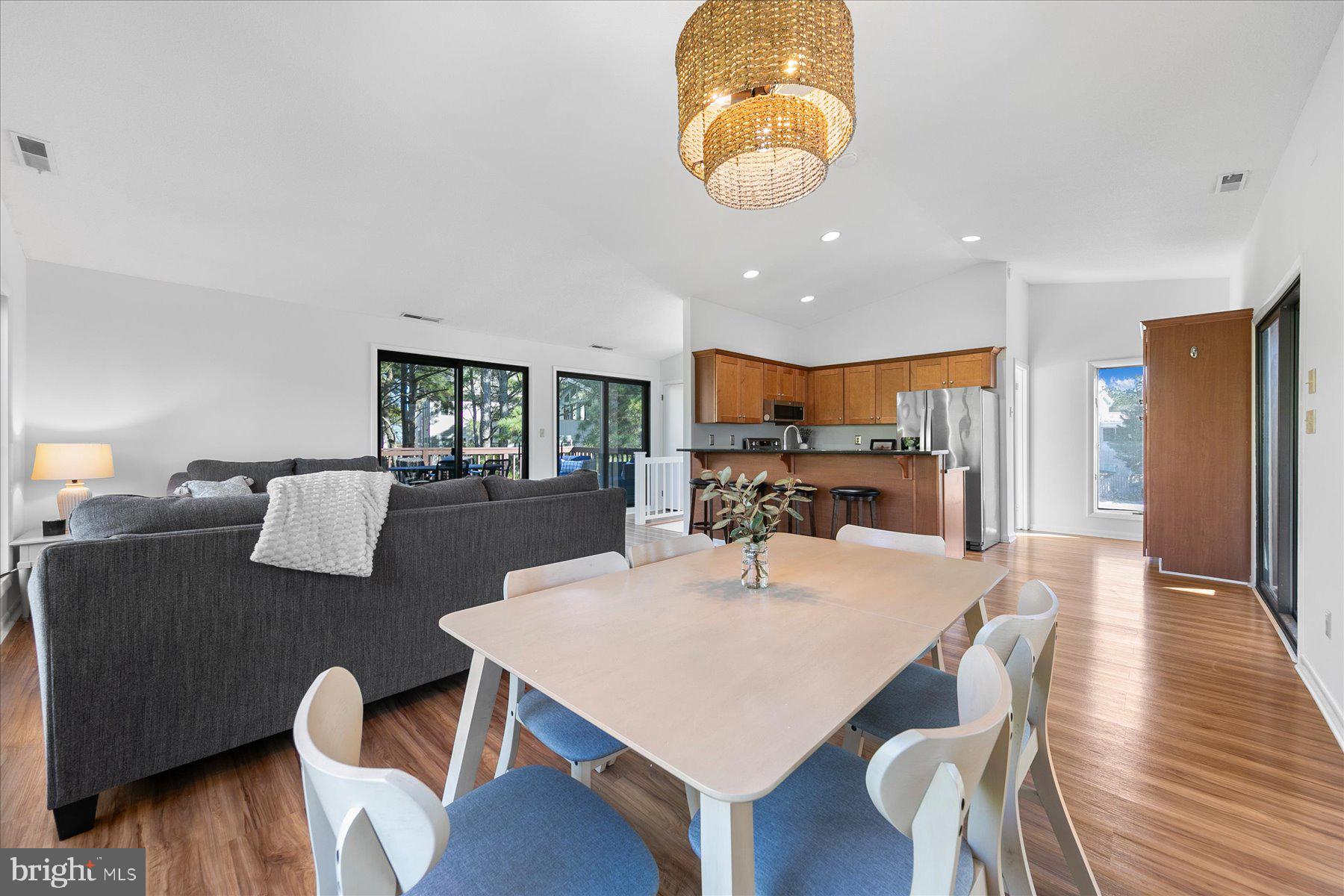 39692 Kittiwake Road Bethany Beach, DE 19930 - Photo 13 of 32 a large kitchen with a table and chairs