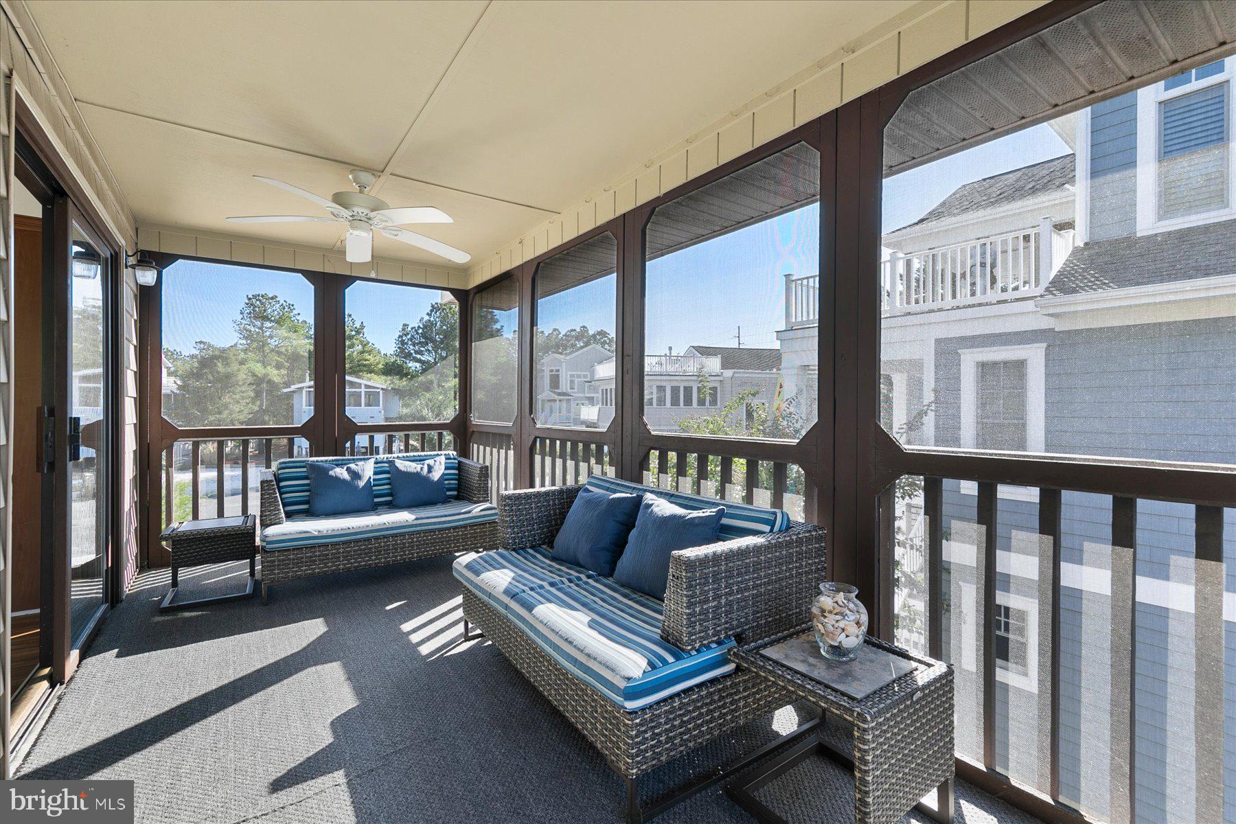 39692 Kittiwake Road Bethany Beach, DE 19930 - Photo 14 of 32 a living room with furniture and a floor to ceiling window