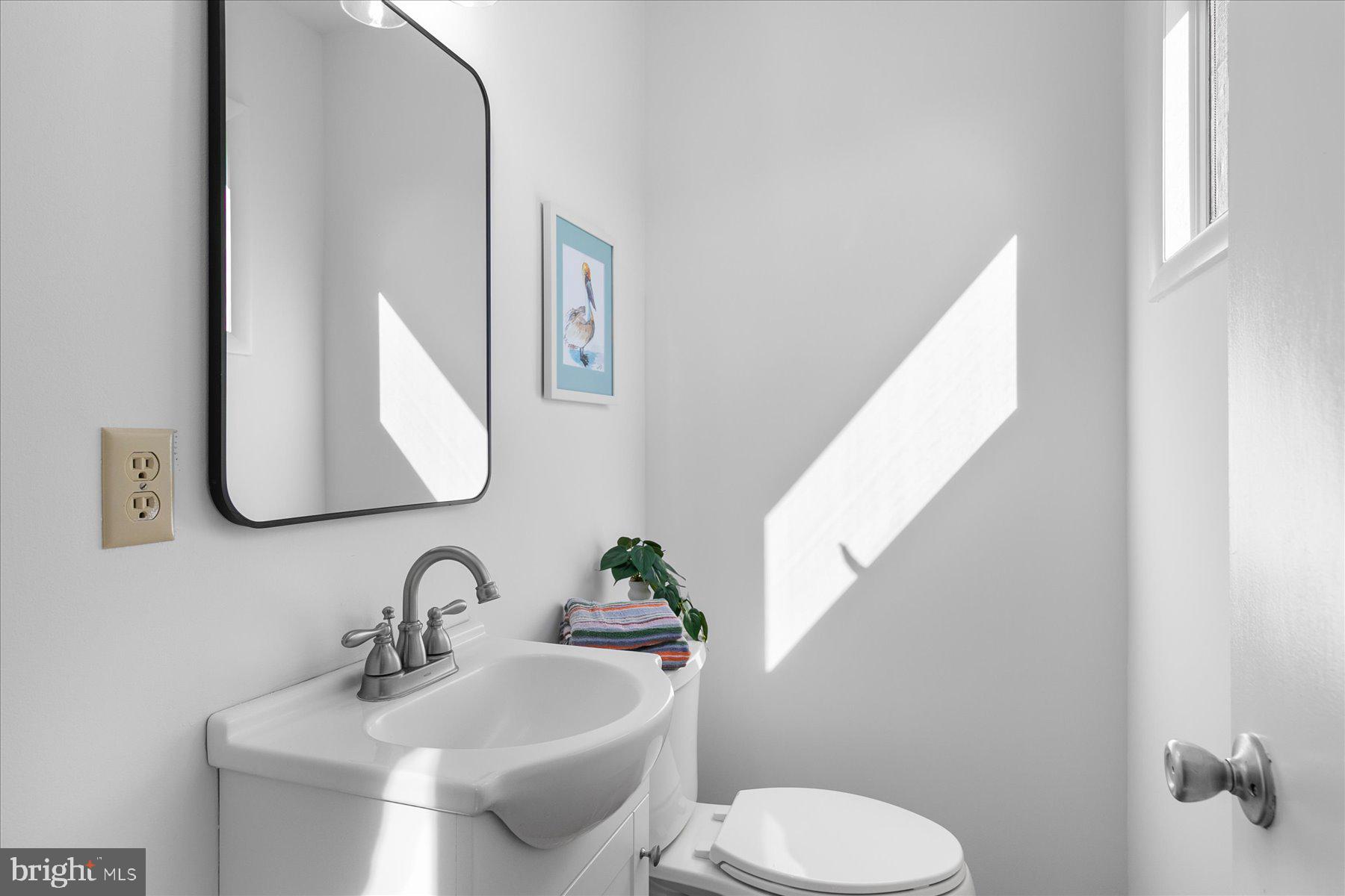 39692 Kittiwake Road Bethany Beach, DE 19930 - Photo 19 of 32 a bathroom with a toilet sink and mirror