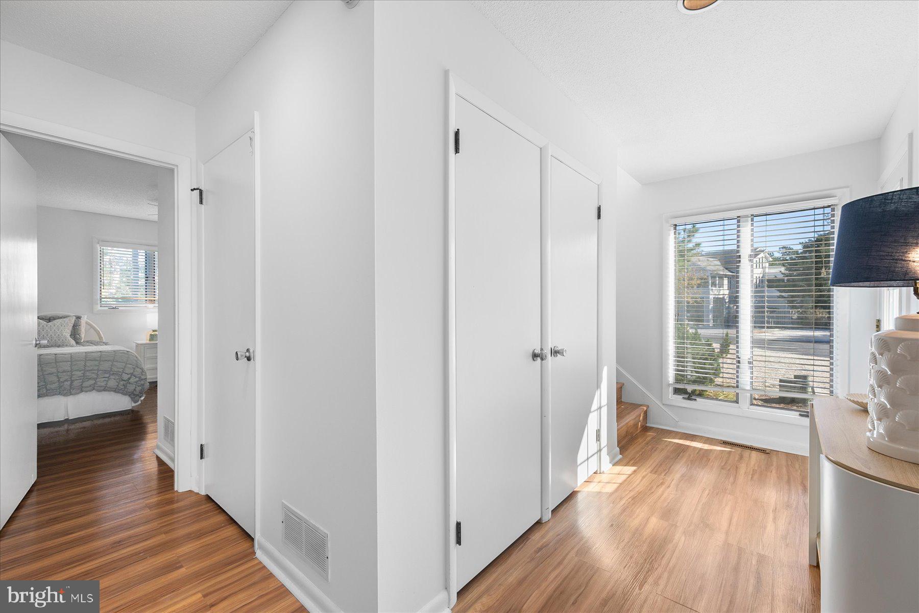 39692 Kittiwake Road Bethany Beach, DE 19930 - Photo 20 of 32 a view of a hallway with wooden floor and windows