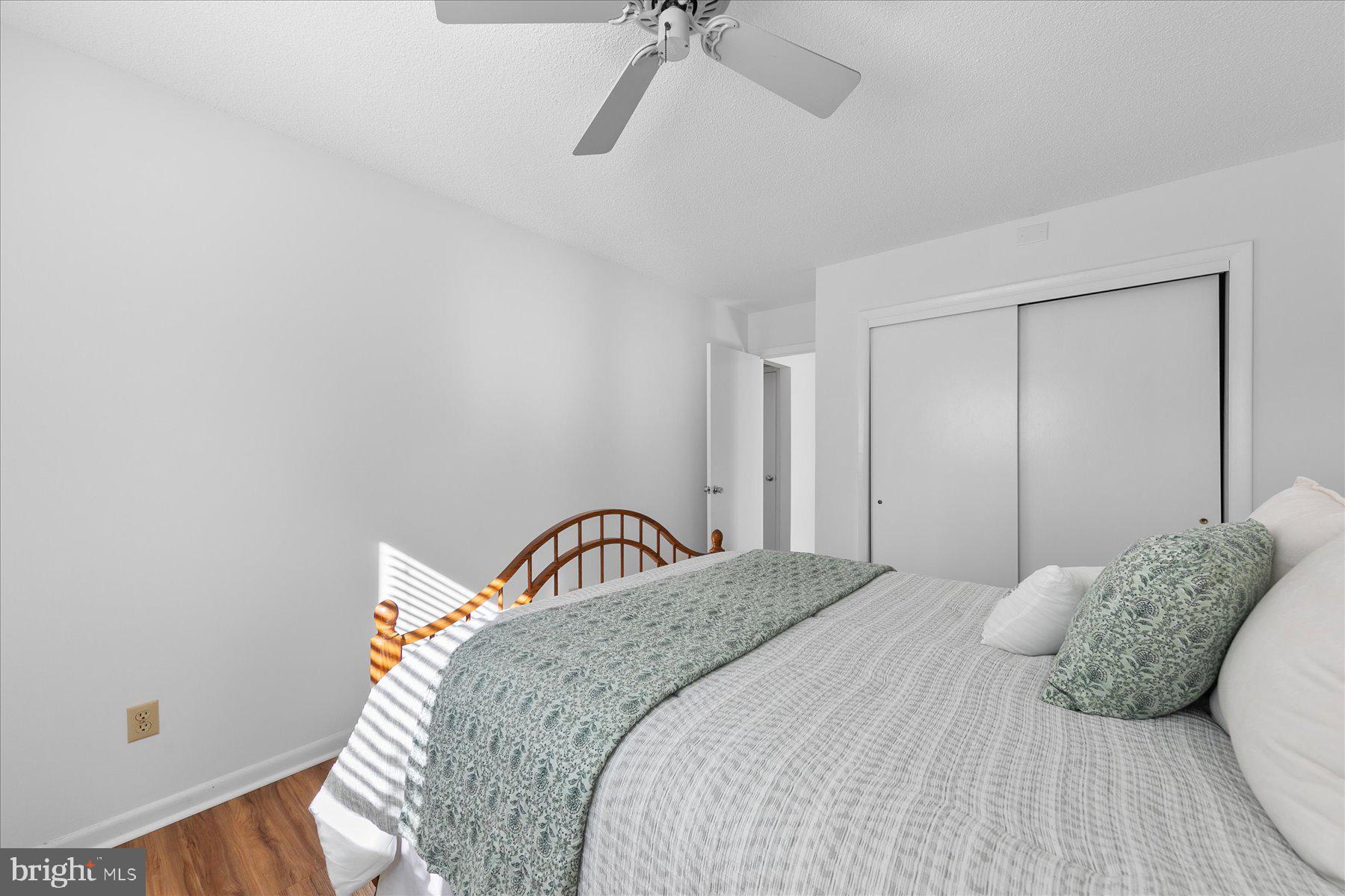39692 Kittiwake Road Bethany Beach, DE 19930 - Photo 28 of 32 a bedroom with a bed and ceiling fan