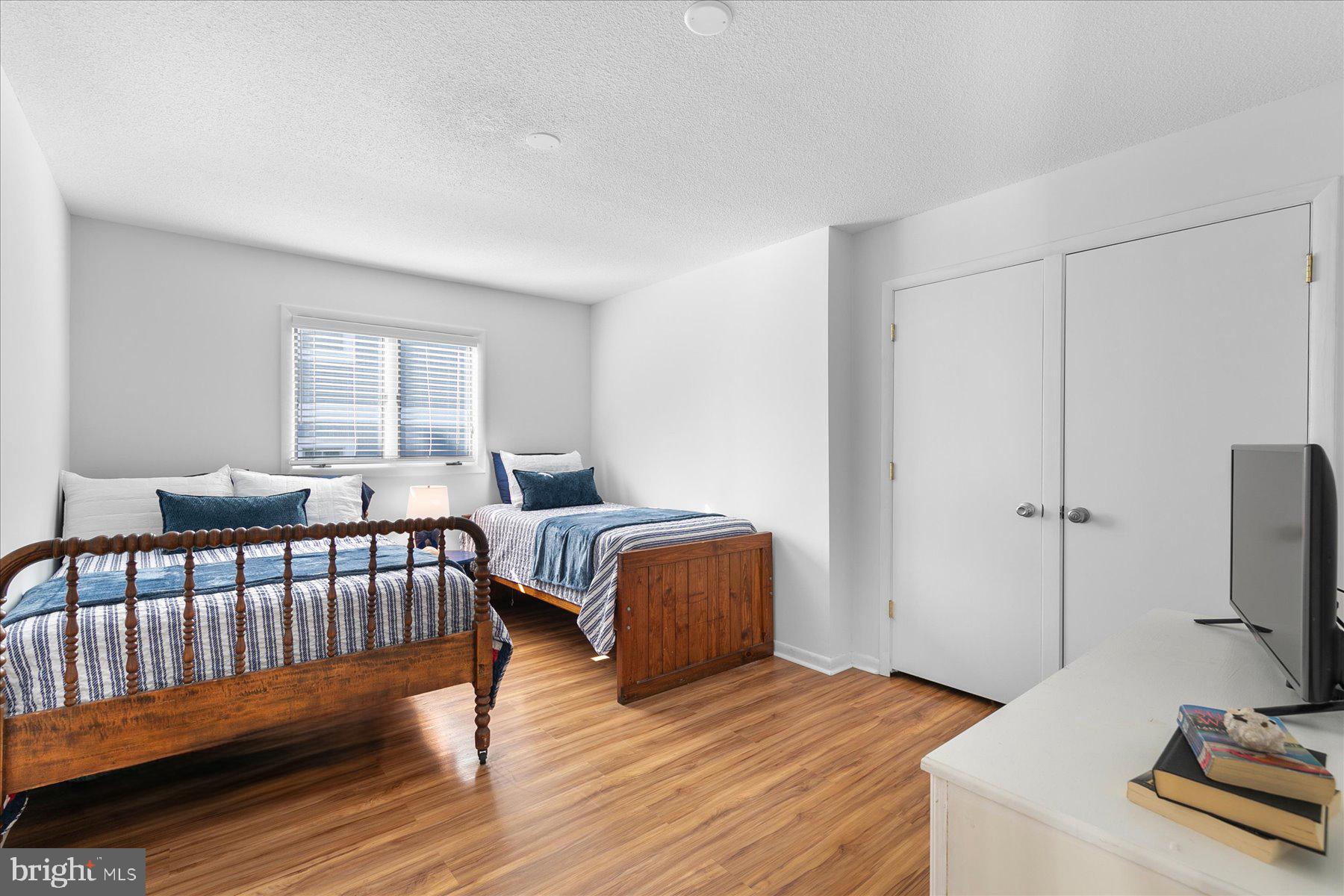 39692 Kittiwake Road Bethany Beach, DE 19930 - Photo 30 of 32 a bedroom with furniture and a window