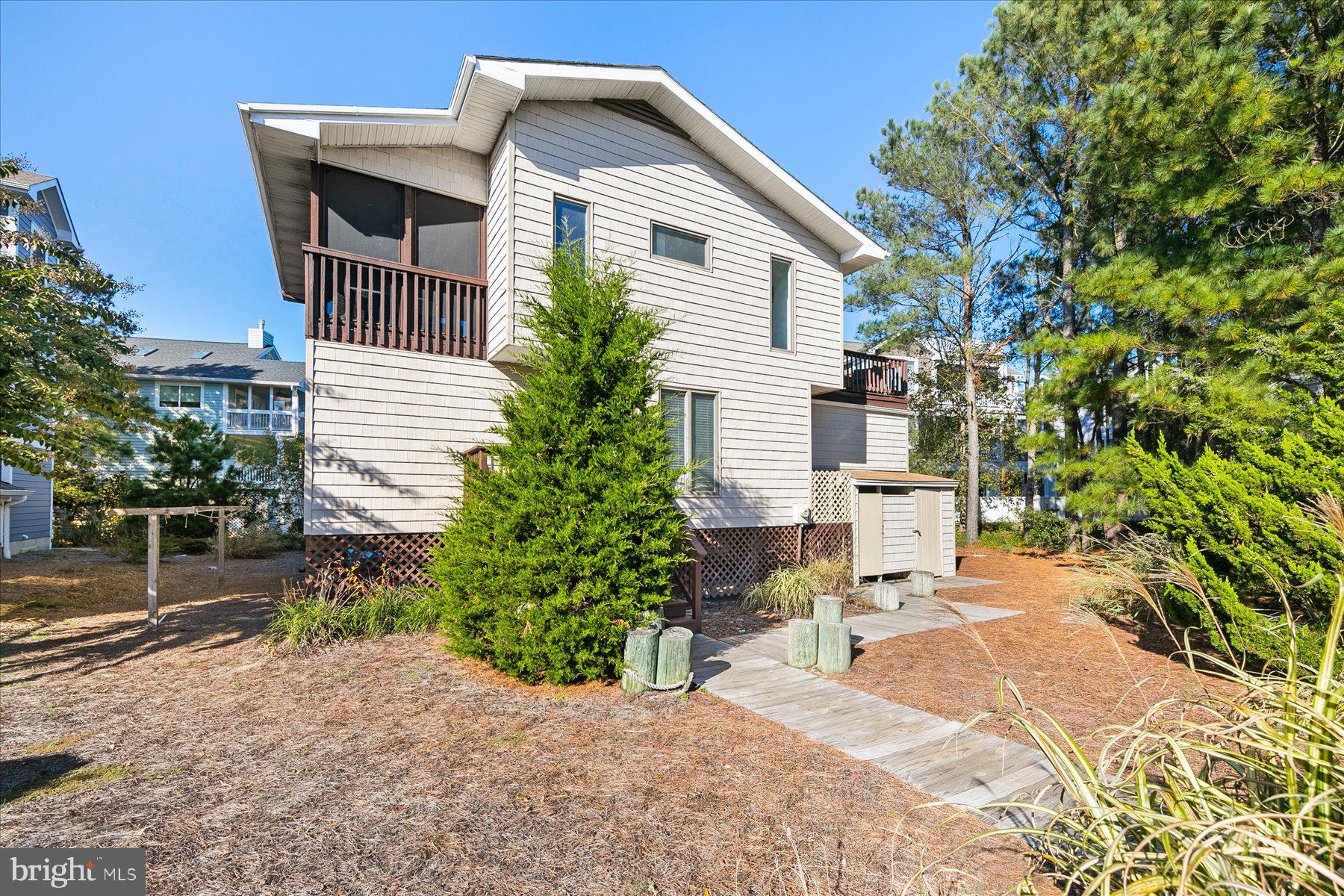 39692 Kittiwake Road Bethany Beach, DE 19930 - Photo 3 of 32 a view of a backyard with sitting area