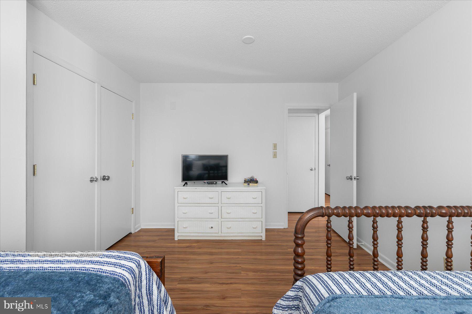 39692 Kittiwake Road Bethany Beach, DE 19930 - Photo 31 of 32 a bedroom with a bed and a flat screen tv