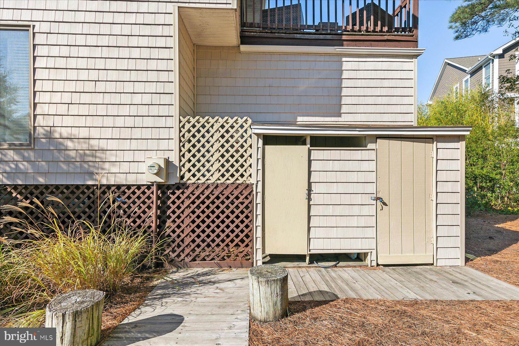 39692 Kittiwake Road Bethany Beach, DE 19930 - Photo 32 of 32 a backyard of a house with wooden fence