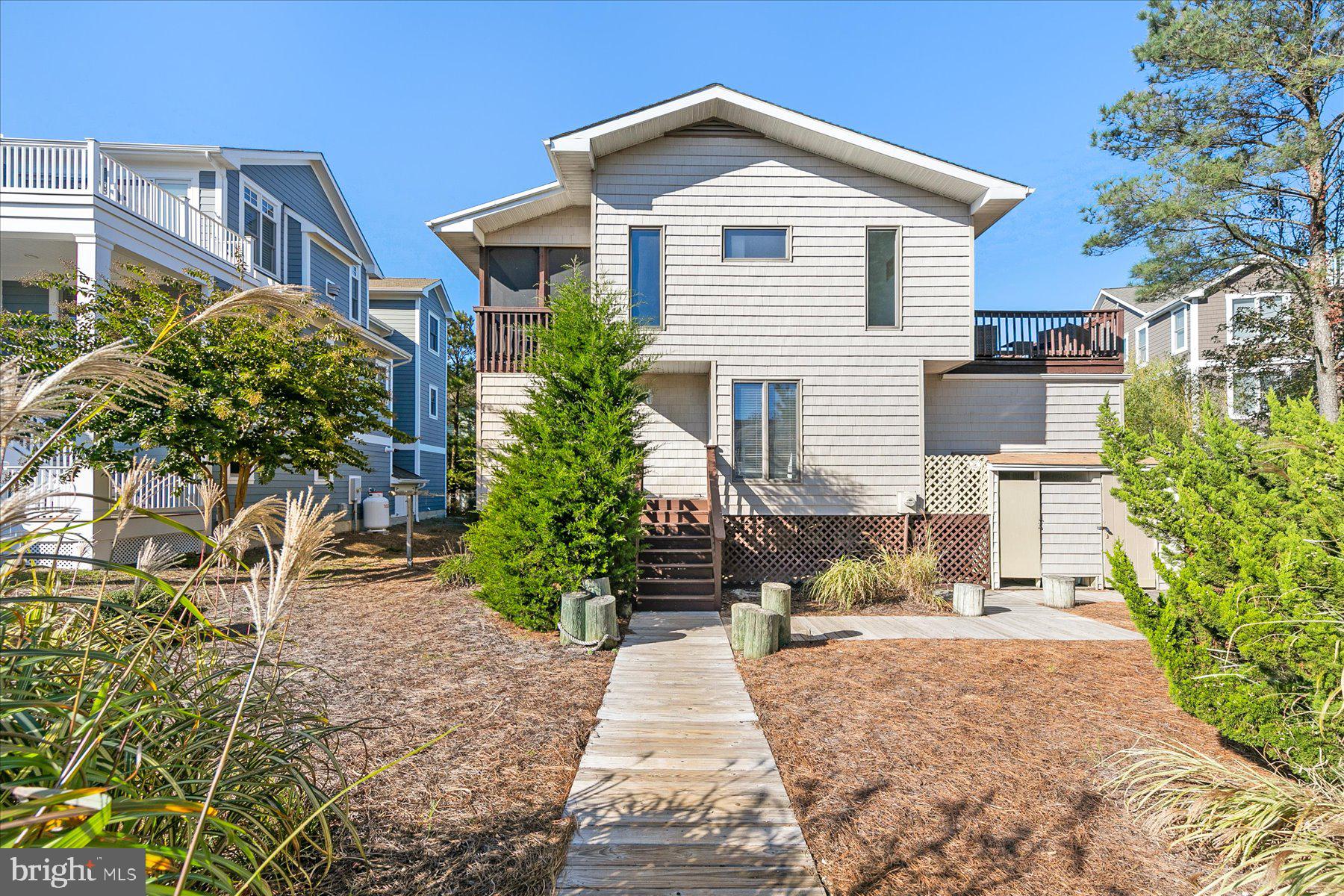 39692 Kittiwake Road Bethany Beach, DE 19930 - Photo 4 of 32 a front view of a house with a yard