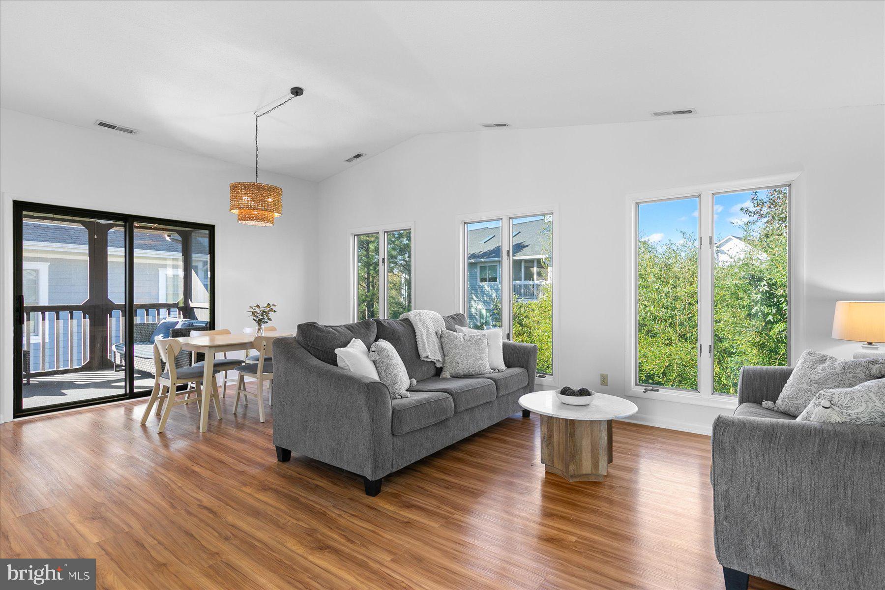39692 Kittiwake Road Bethany Beach, DE 19930 - Photo 5 of 32 a living room with furniture and a wooden floor