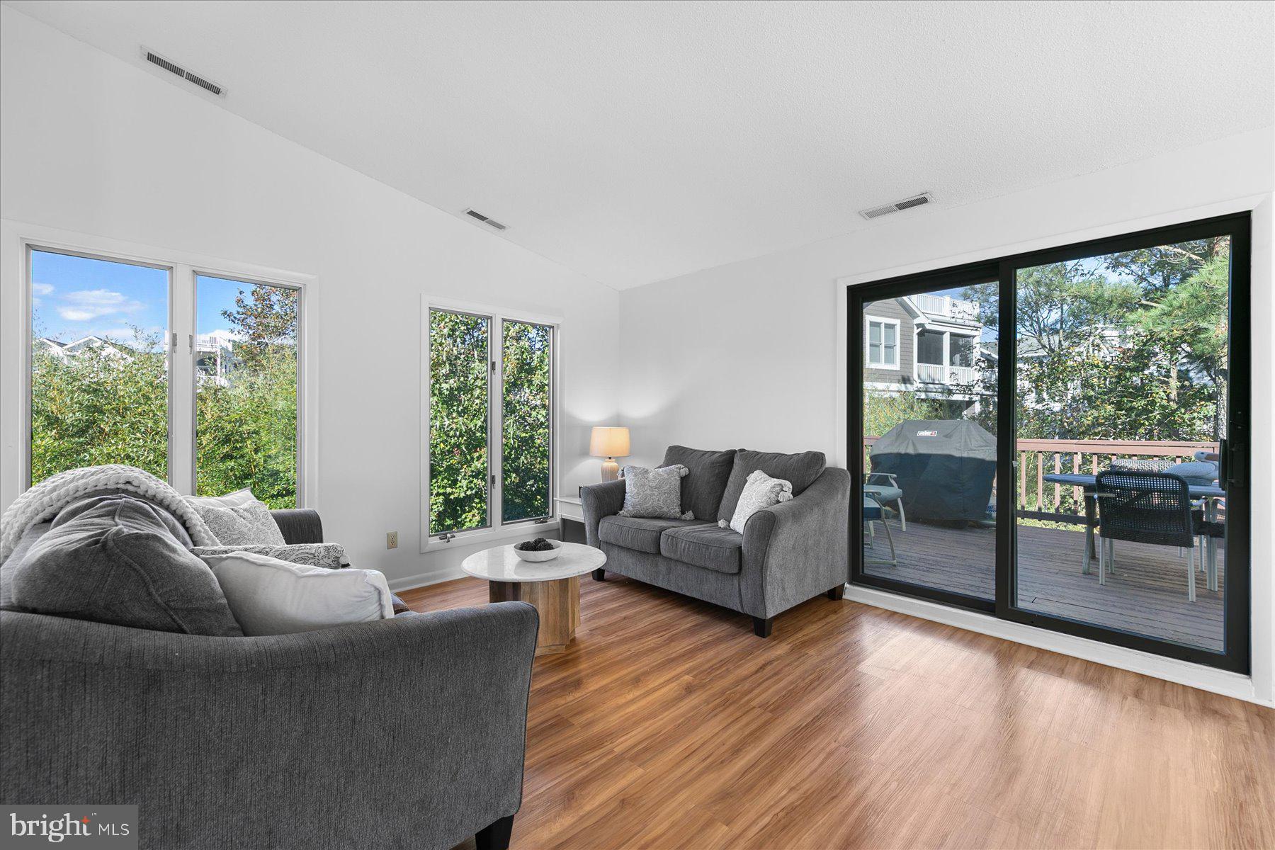 39692 Kittiwake Road Bethany Beach, DE 19930 - Photo 6 of 32 a living room with furniture and a large window