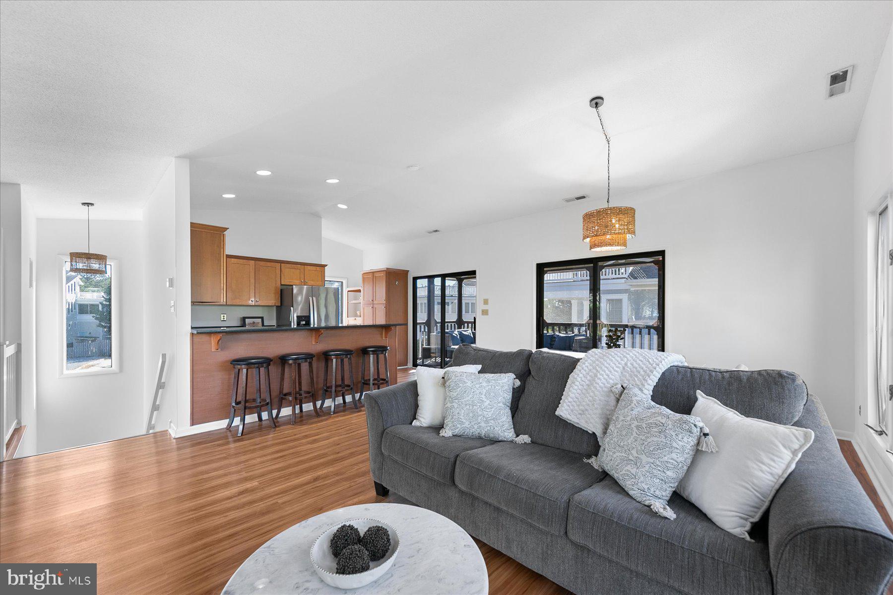 39692 Kittiwake Road Bethany Beach, DE 19930 - Photo 7 of 32 a living room with furniture and a wooden floor