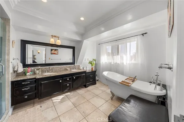 a bathroom with a granite countertop shower sink and mirror