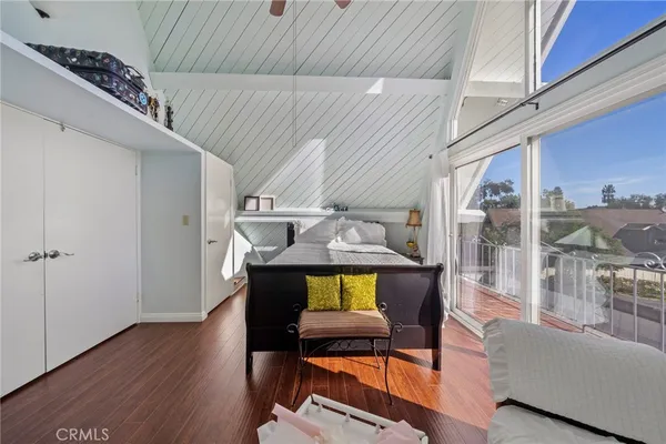 a view of a livingroom with furniture wooden floor and windows
