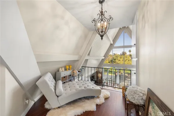 a living room with furniture a flat screen tv and kitchen view