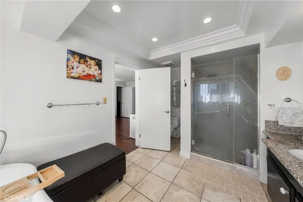 a living room with furniture a flat screen tv and kitchen view
