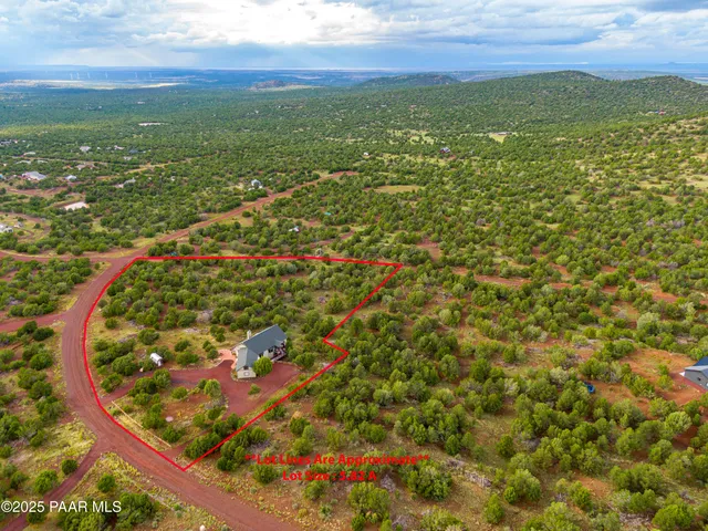 a view of a porch with wooden floor next to a yard