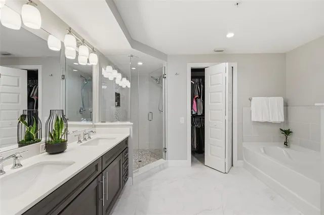 a bedroom with a bed window and a flat screen tv