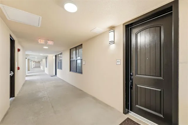 a view of a hallway to a livingroom and a dining room with furniture