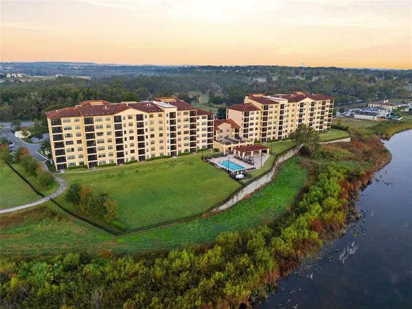 a living room with furniture large windows and a flat screen tv