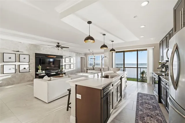 a living room with furniture large windows and a flat screen tv