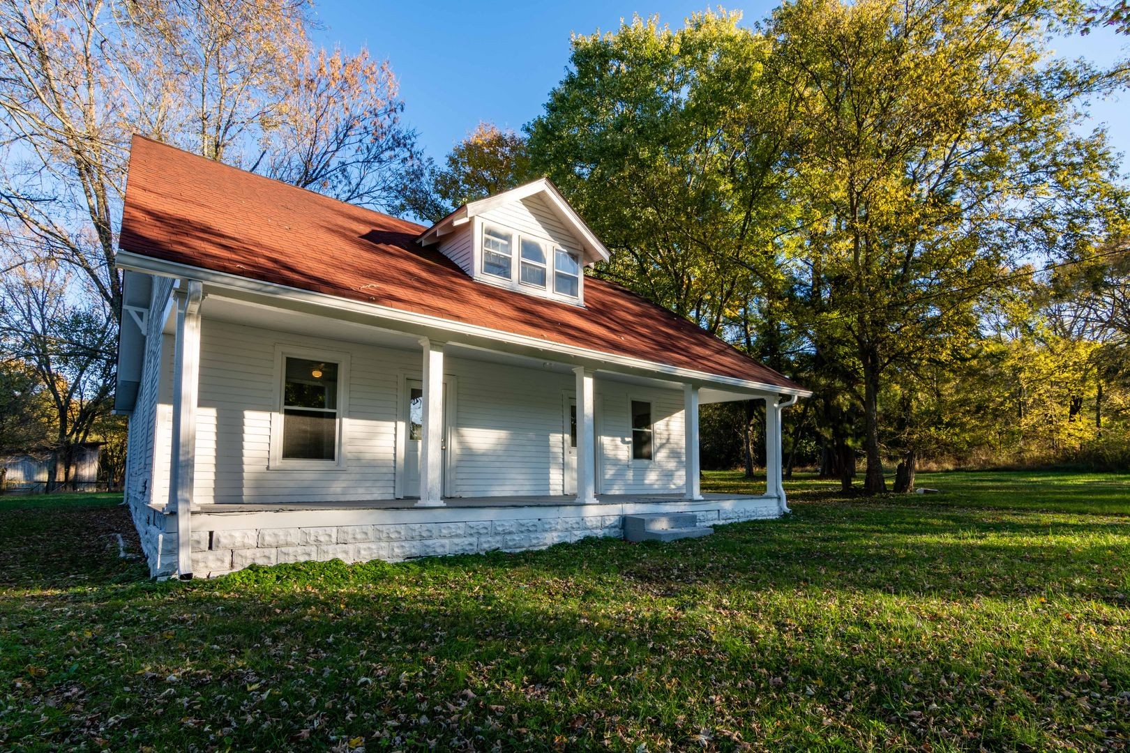 a front view of house with yard and green space