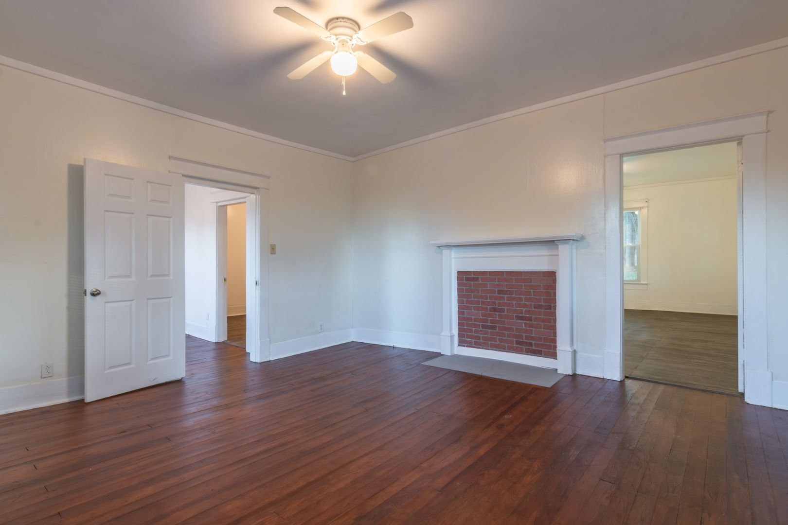 1809 Cairo Bend Road Lebanon, TN 37087 - Photo 4 of 17 an empty room with wooden floor chandelier fan and windows