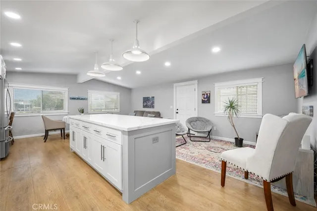 a open kitchen with stainless steel appliances granite countertop a stove and a view of living room