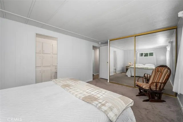 a bedroom with a bed chair and couch