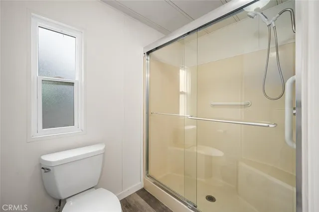 a bathroom with a toilet and shower
