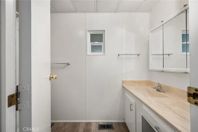 a room with a sink and cabinets