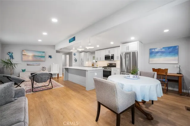 a large kitchen with a table and chairs