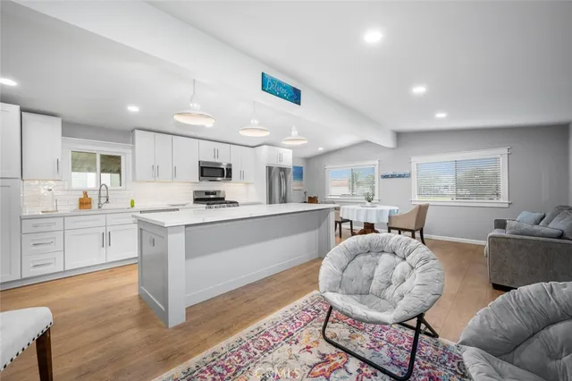 a living room with kitchen island furniture and a wooden floor